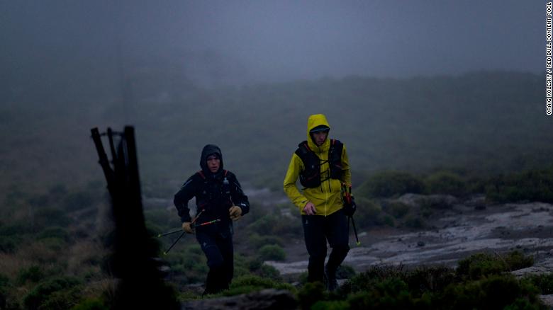 Griesel and Sandes making a big push up one of Lesotho&#39;s many mountains during a particularly rainy day.
