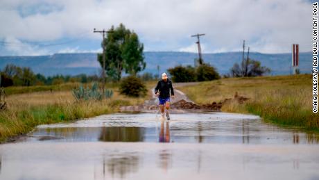 Sandes fording a river during the 16-day run around Lesotho.  He says he went through a pair of socks every day.