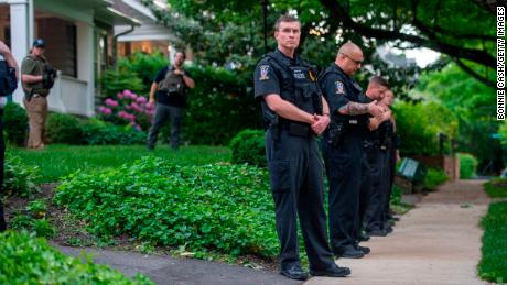CHEVY CHASE, MD - MAY 18: Police officers stand outside the home of U.S. Supreme Court Justice Brett Kavanaugh in anticipation of an abortion-rights demonstration on May 18, 2022 in Chevy Chase, Maryland. Protests have been organized intermittently outside the homes of justices who signed onto a draft opinion that would overturn the landmark Roe v Wade decision, which made abortion legal across the U.S. in 1973. (Photo by Bonnie Cash/Getty Images)