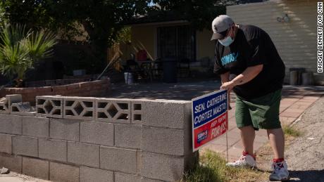 &quot;They are telling me that they are struggling,&quot; Villanueva, seen her placeing a sign in the yard of a home in an East Las Vegas neighborhood, says of the people he talks to about rising prices. 