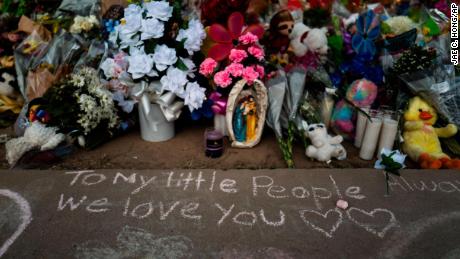 Messages were written in chalk on a sidewalk next to a memorial at Robb Elementary School in Uvalde, Texas, on May 31 to honor the victims killed in the shooting. 