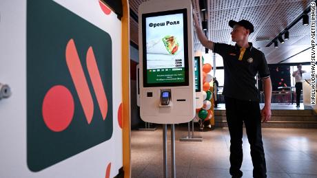 An employee cleans a self-ordering machine in the Russian version of a former McDonald's restaurant before the opening ceremony, in Moscow.