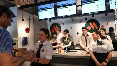 An employee gives a customer his food order at a Vkusno &amp; Tochka restaurant in Moscow, after the opening ceremony.