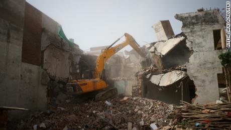 A bulldozer demolishes the house of a Muslim man in Prayagraj, India, who Uttar Pradesh state authorities accuse of being involved in riots last week.