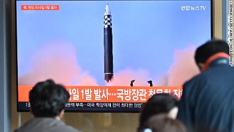 People in Seoul watch a news broadcast showing footage of a North Korean missile test. 