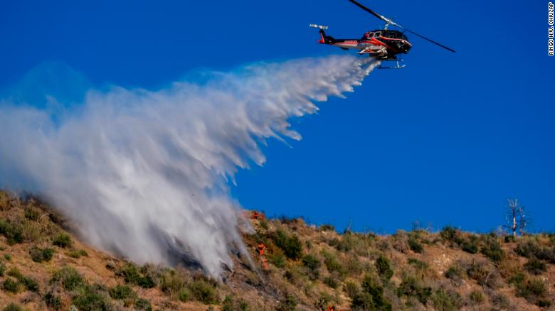 Officials go door-to-door for mandatory evacuations after fire expands in Southern California’s Angeles National Forest