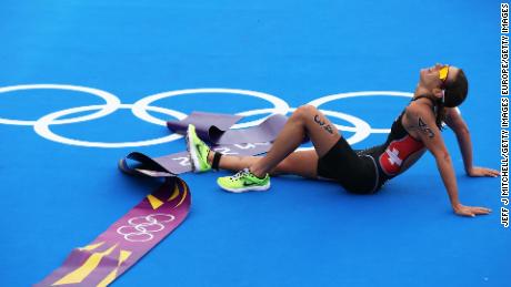 An exhausted Spirig lies on the ground at the end of the London 2012 Olympic Games. 