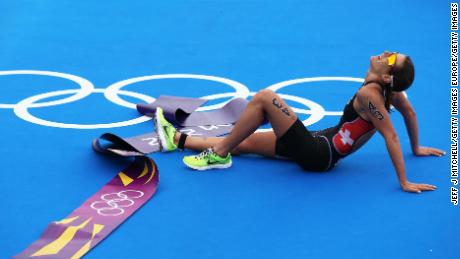 LONDON, ENGLAND - AUGUST 04:  Nicola Spirig of Switzerland lays on the ground after finishing the Women&#39;s Triathlon on Day 8 of the London 2012 Olympic Games at Hyde Park on August 4, 2012 in London, England.  (Photo by Jeff J Mitchell/Getty Images)