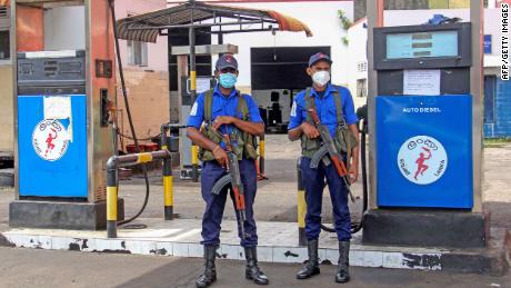 Naval officers guard a closed fuel station in Colombo, Sri Lanka on June 12.