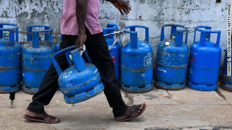 A man joins a queue to fill his gas cylinder in Colombo, Sri Lanka. 