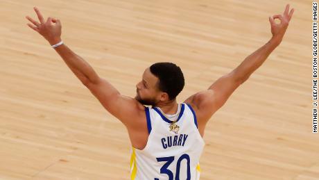 Curry reacts after teammate Klay Thompson makes a three-point basket against the Celtics.