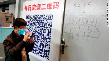 A patient scans a QR code at a makeshift hospital for people infected with Covid-19 in Shanghai April 24.