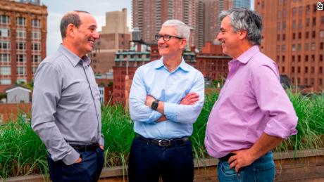 Major League Soccer commissioner Don Garber, left, Apple CEO Tim Cook, center, and Apple senior vice president of Services Eddy Cue talk in New York, June 8, 2022.