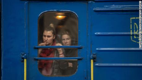 Passengers watch from a train at Lviv-Holovnyi rail station as displaced Ukrainians flee to Poland in February. 