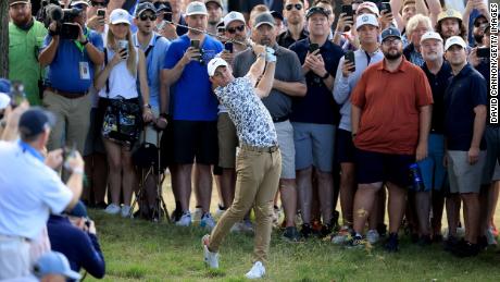 McIlroy plays his second shot on the 13th hole.