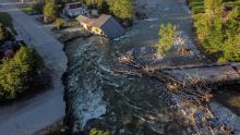 A house sits in Rock Creek after floodwaters washed away a road and a bridge in Red Lodge, Montana, on Wednesday, June 15.