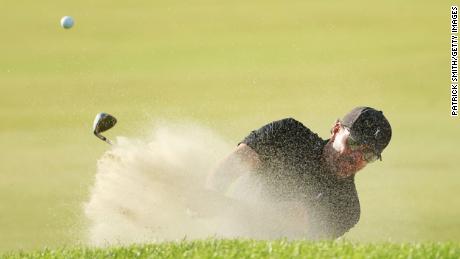 Mickelson plays a shot from a bunker on the 15th hole.