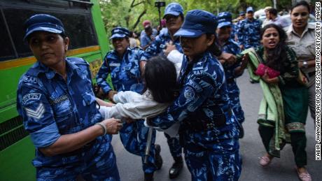 Indian security personnel detain a demonstrator during protests in New Delhi on Thursday against the government&#39;s new military recruitment scheme.