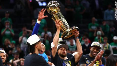 Stephen Curry of the Golden State Warriors raises the Larry O&#39;Brien Championship Trophy after defeating the Celtics in Game 6 of the 2022 NBA Finals on June 16, 2022 in Boston. 