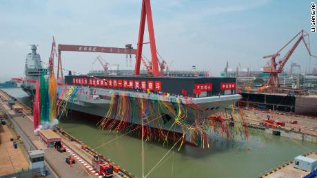 In this photo released by Xinhua News Agency, colored smoke mark the launch ceremony for China&#39;s third aircraft carrier christened Fujian at a dry dock in Shanghai on Friday, June 17, 2022. China on Friday launched its third aircraft carrier, the first such ship to be both designed and built entirely within the country. (Li Gang/Xinhua via AP)