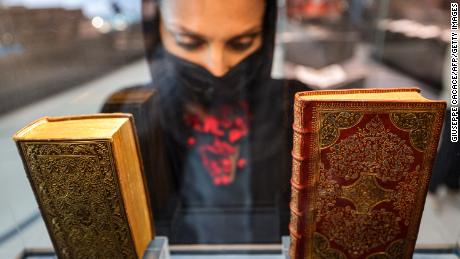 A visitor views a 1644 manuscript copy of the & quot; Sacred Prayers of the Christian Soul & quot;  by Pierre Moreau (R) on display at the newly-opened Mohammed Bin Rashid library (MBRL) in Dubai on June 16.