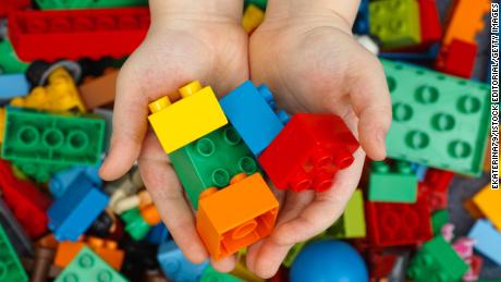Lego Double Bricks in a child's hands.