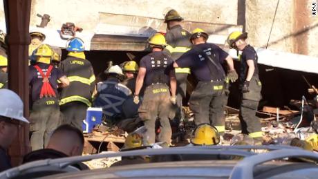 Firefighters scoured the rubble.