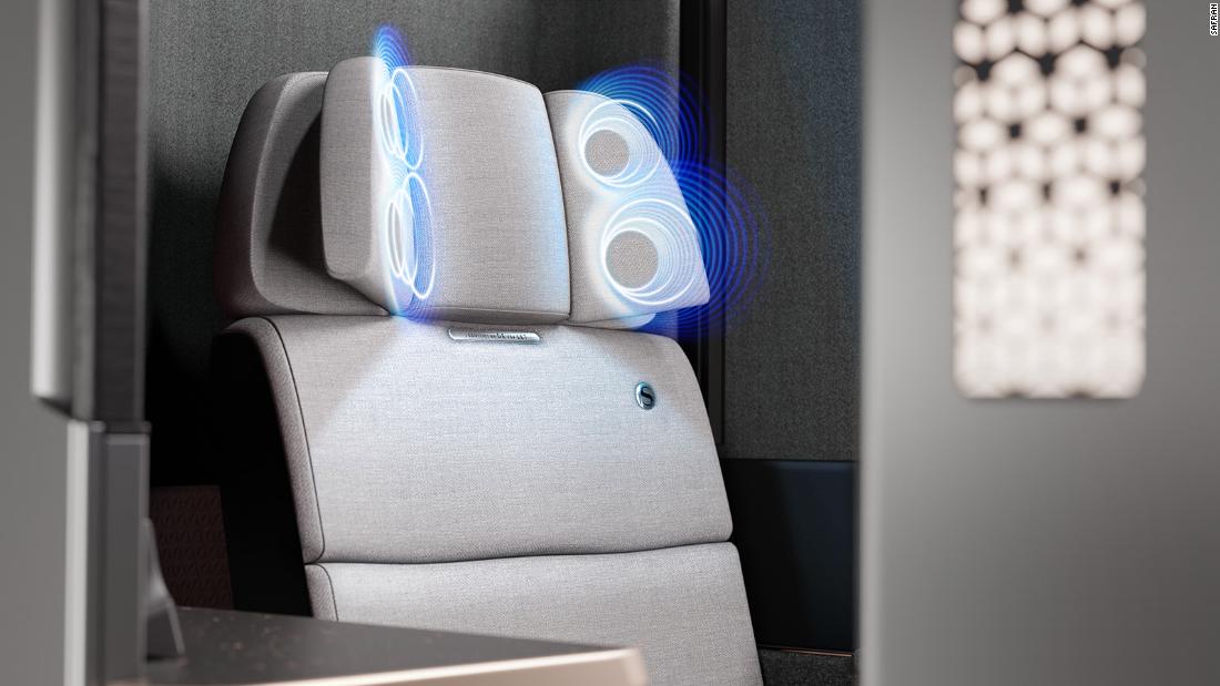 The airplane seat with headphones installed into the headrest