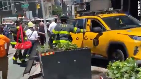 Police say video of the incident shows the taxi jumped the sidewalk after colliding with a cyclist. 