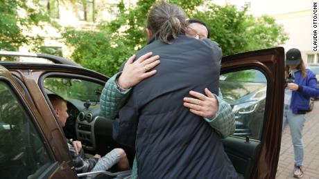 The Reverend Grigory Mikhnov-Vaitenko embraces Shishkina, one of the thousands he says he was able to help.