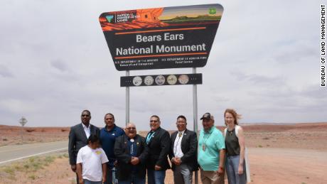 USDA&#39;s Under Secretary for Natural Resources and Environment Homer Wilkes, far left, representatives of five Native American tribes, and Tracy Stone-Manning, director of the Bureau of Land Management, far right, are pictured in front of the newly installed Bears Ears National Monument sign on June 18, 2022.