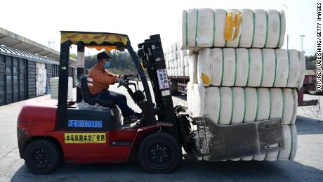 A forklift driver loads cotton from Xinjiang at a railway freight station in Jiujiang, China, on March 26, 2021.