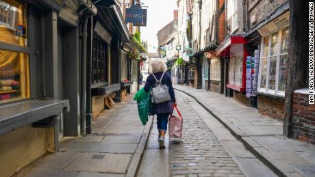 A shopper walks along the Shambles in York, UK, on Monday, June 20, 2022. Inflation hit a 40-year high last month to 9.4%. Photographer: Ian Forsyth/Bloomberg via Getty Images