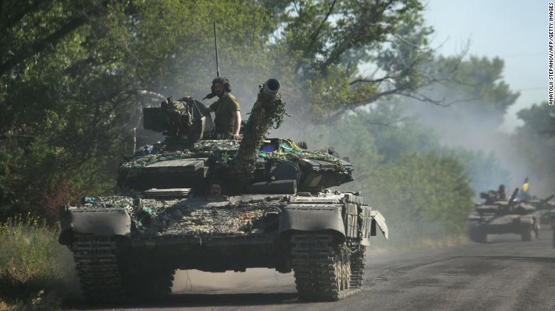 Ukrainian troops travel in armored vehicles on a road in the eastern Ukrainian region of Donbas on June 21, 2022.