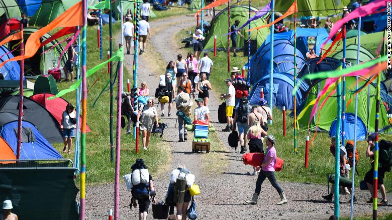 Festivalgoers arrive to attend the Glastonbury festival in the village of Pilton, in Somerset, South West England, on Wednesday.