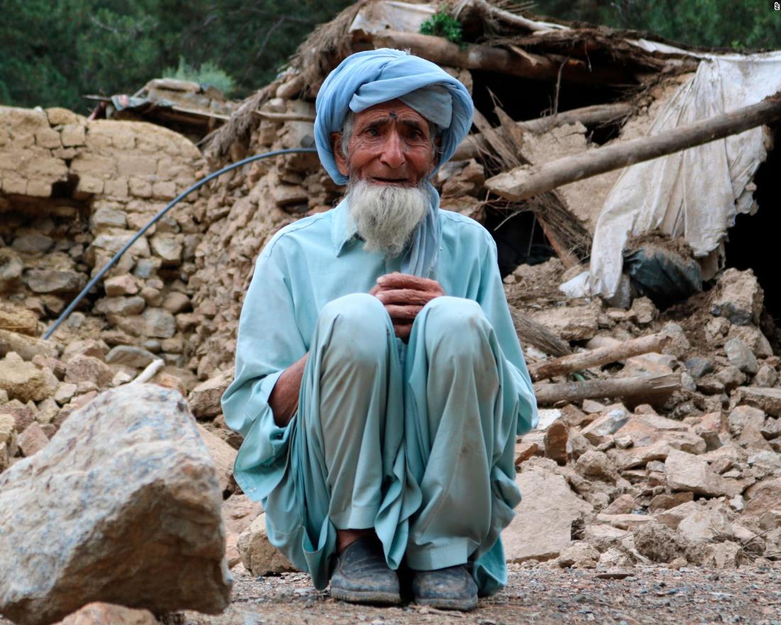 An old man sits near his house that was destroyed in the earthquake on June 22.