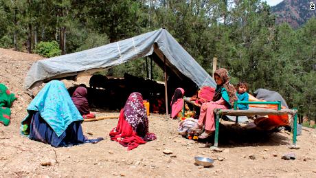 Afghan villagers sit outside a tent after their house was damaged in an earthquake in Spera, Khost province, on June 22.