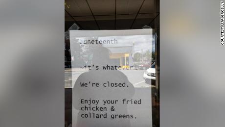 Photos show the sign taped to the window.