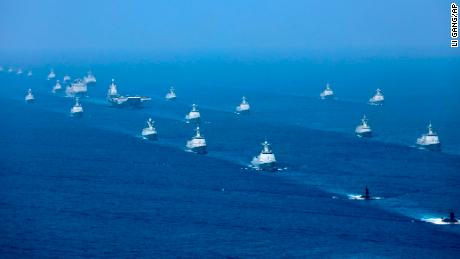 China&#39;s Liaoning aircraft carrier is accompanied by navy frigates and submarines during an exercise in the South China Sea.