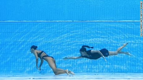 A member of Team USA (R) swims to recover USA&#39;s Anita Alvarez (L), from the bottom of the pool during an incident in the women&#39;s solo free artistic swimming finals, during the Budapest 2022 World Aquatics Championships at the Alfred Hajos Swimming Complex in Budapest on June 22, 2022.