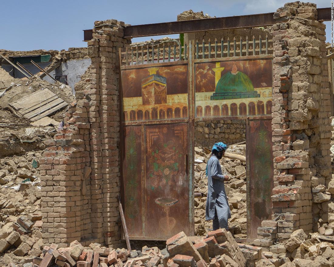 An Afghan man stands besides a door of a house damaged by an earthquake in Bernal district, Paktika province, on June 23.