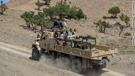 Members of a Taliban rescue team return from affected villages in the aftermath of the earthquake.