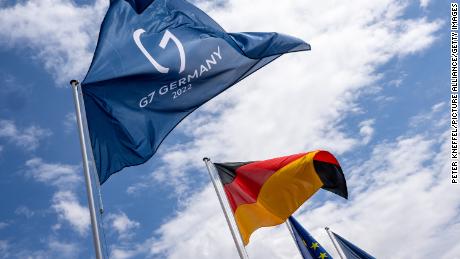 24 June 2022, Bavaria, Garmisch-Partenkirchen: Flags of the G7 Summit (l-r), Germany and the European Union fly at the press center under a white and blue sky. The G7 Summit is scheduled to take place at Schloss Elmau from June 26 to 28, 2022. 