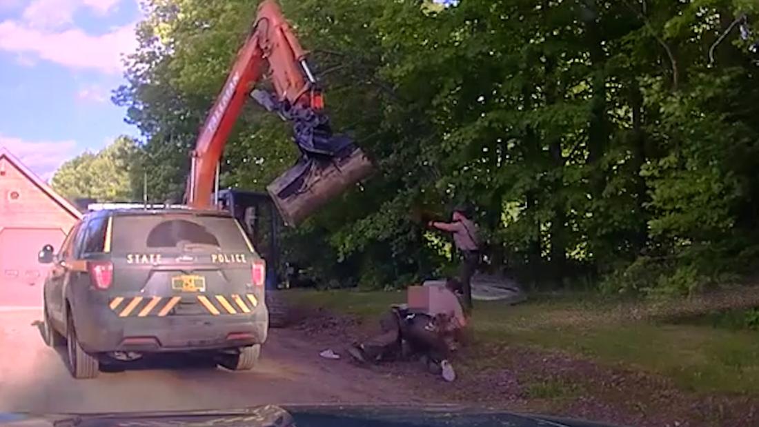 Dashcam: Dad tries to stop son's arrest by swinging excavator at police