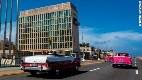 FILE - Tourists ride classic convertible cars on the Malecon beside the U.S. Embassy in Havana, Cuba, on Oct. 3, 2017. The State Department is preparing to compensate victims of mysterious brain injuries colloquially known as &quot;Havana Syndrome&quot; with six-figure payments, according to officials and a congressional aide. Current and former State Department staff and their families who suffered from &quot;qualifying injuries&quot; since cases were first reported among U.S. embassy personnel in Cuba in 2016 will receive payments of between roughly $100,000 and $200,000 each, the officials and aide said. (AP Photo/Desmond Boylan, File)