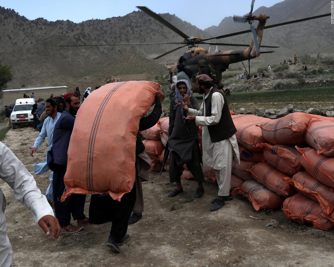 A man carries supplies in an area affected by the earthquake in Gayan, Afghanistan, on June 23.