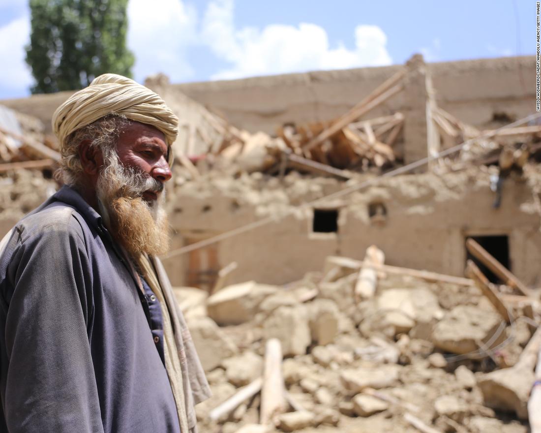 A man stands near debris of a building after the quake shakes border provinces of Paktika, Afghanistan on June 23.