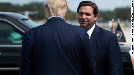 US President Donald Trump is greeted by Florida Governor Ron DeSantis at Southwest Florida International Airport October 16, 2020, in Fort Myers, Florida. (Photo by Brendan Smialowski / AFP) (Photo by BRENDAN SMIALOWSKI/AFP via Getty Images)