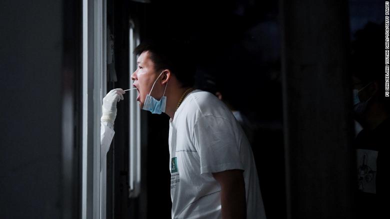 A medical worker takes a swab sample for Covid-19 from a citizen on June 22, 2022 in Beijing, China.