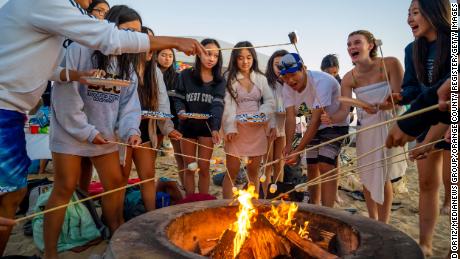 Teenagers attend a birthday party at a California beach this week.